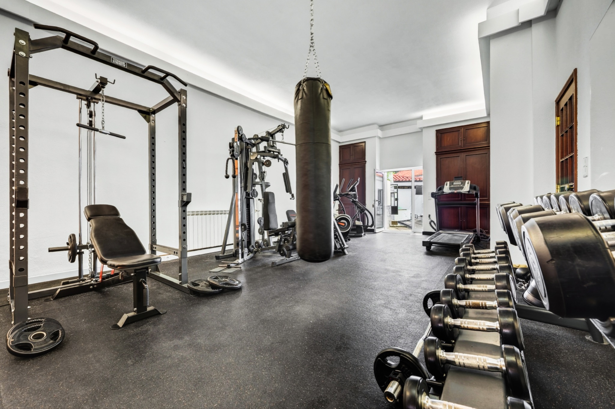Fitness room with free weights, punching bag and exercise equipment