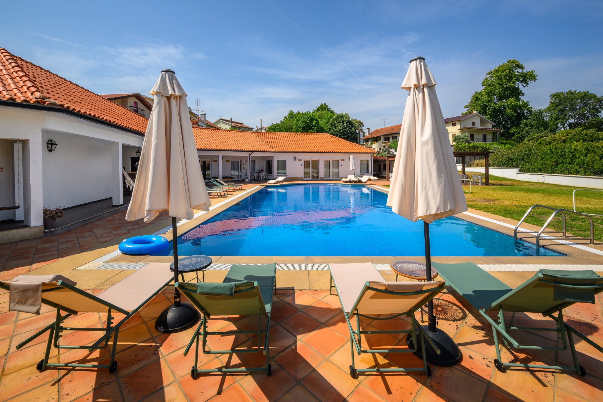 Outdoor pool and sun loungers in the courtyard