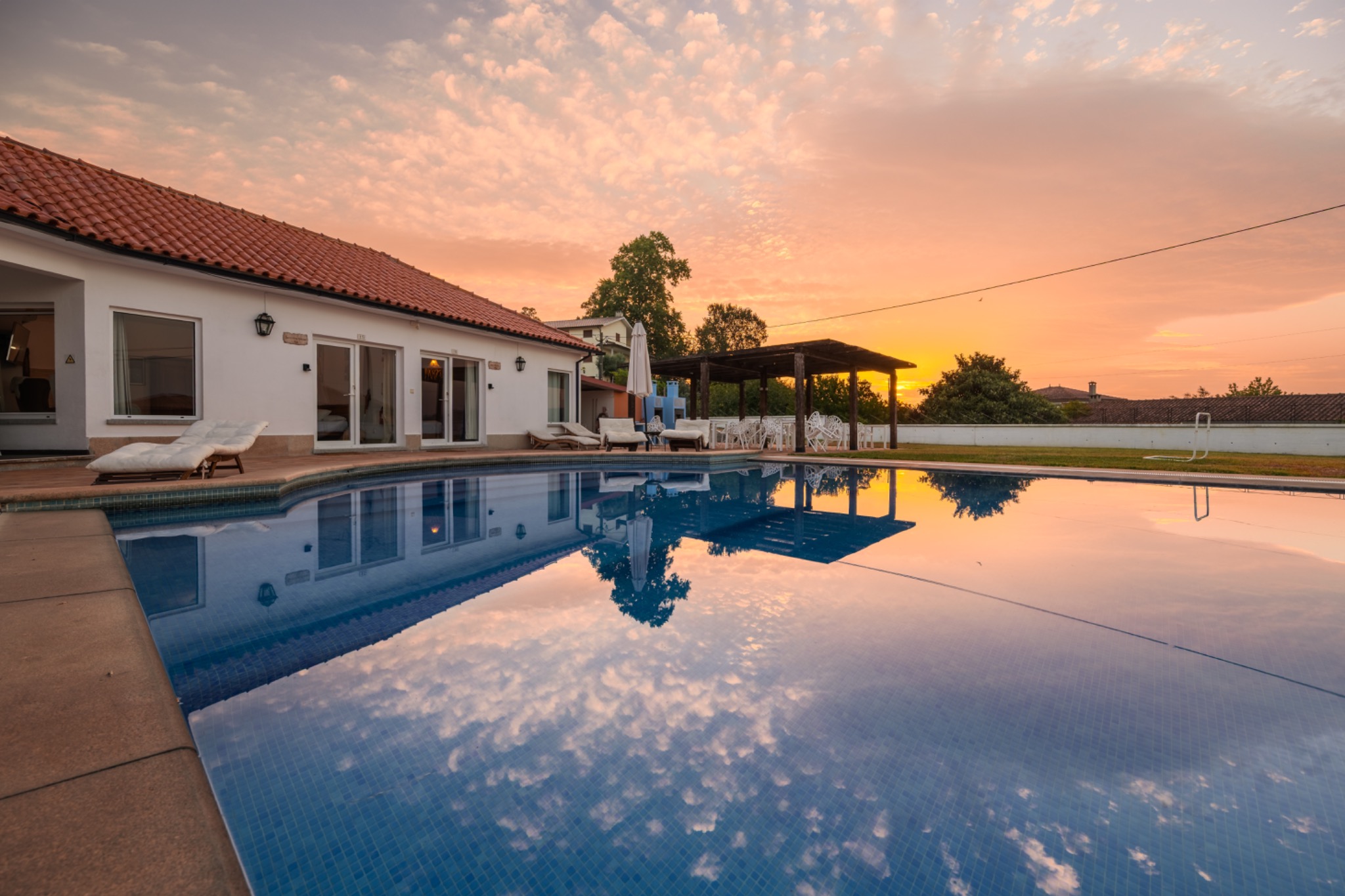 A Casa Branca pool and terrace at sunset