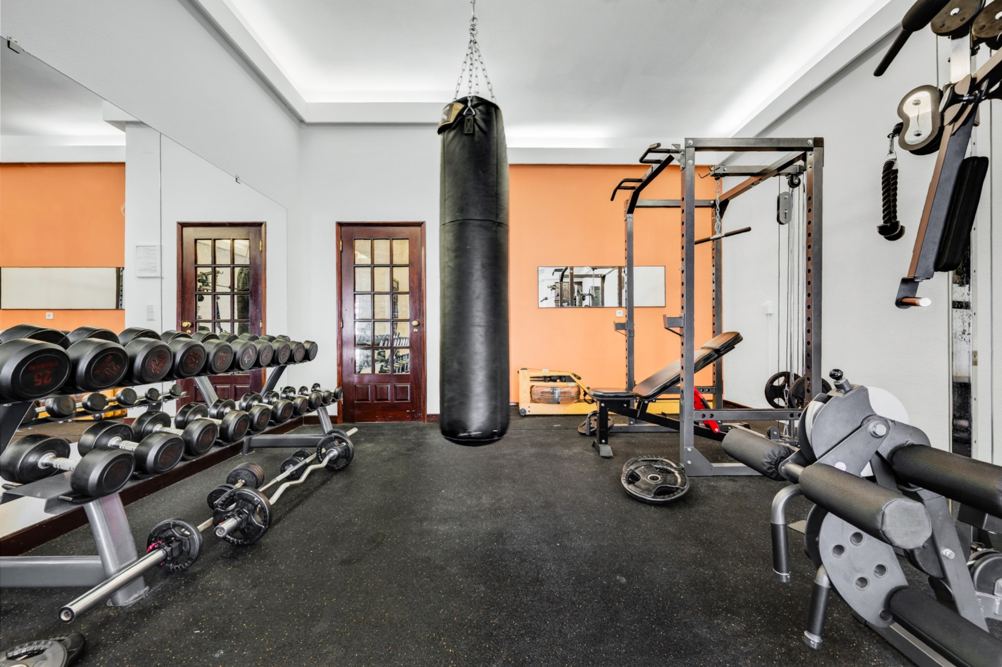 Retreat property gym with weights and punching bag